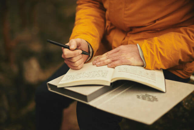 man-in-yellow-writing